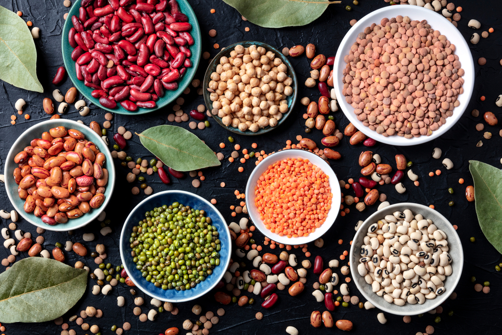 A view from above of dried beans and lentils in bowls loading=